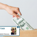 Udstrakt hånd lægger en dollarseddel i en indsamlingskasse
