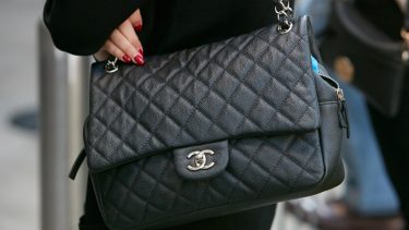 Kvinde med sort Chanel-taske og røde negle
