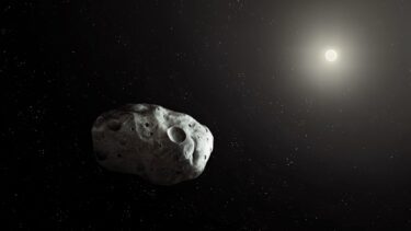 En lille asteroide mod et mørkt verdensrum, delvist oplyst af en fjern stjerrne