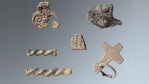 Billeder af artefakter, man har fundet i vikingeskatten, herunder et korsformet vedhæng