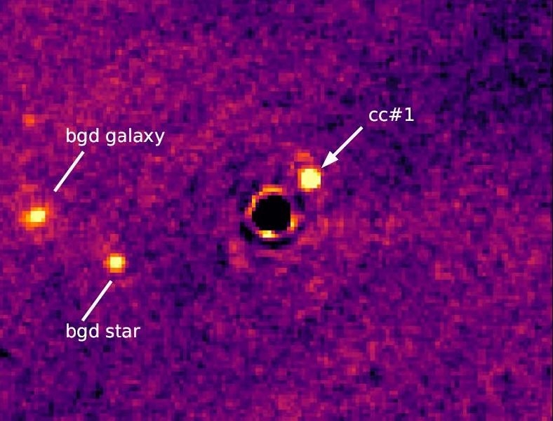 Et astronomisk billede af exoplaneten VWA 7b fanget af James Webb i infrarøde farver, der viser et lyst cirkulært objekt mærket cc#1 nær midten, med etiketter, der angiver bgd-galakse og bgd-stjerne blandt andre lyse pletter på en lilla baggrund.