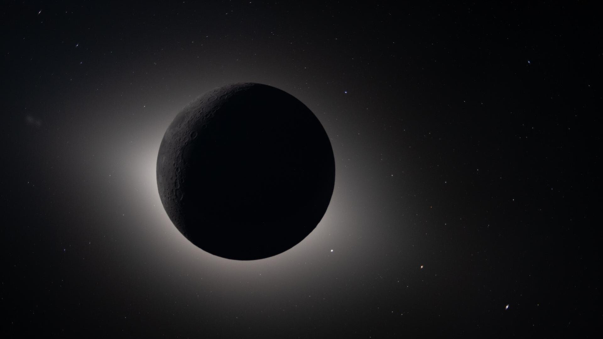 En mørk, skyggefuld planet eller måne er omgivet af en lysende glorie i rummet, som en solformørkelse set fra rummet, med mange svage stjerner spredt ud i baggrunden.