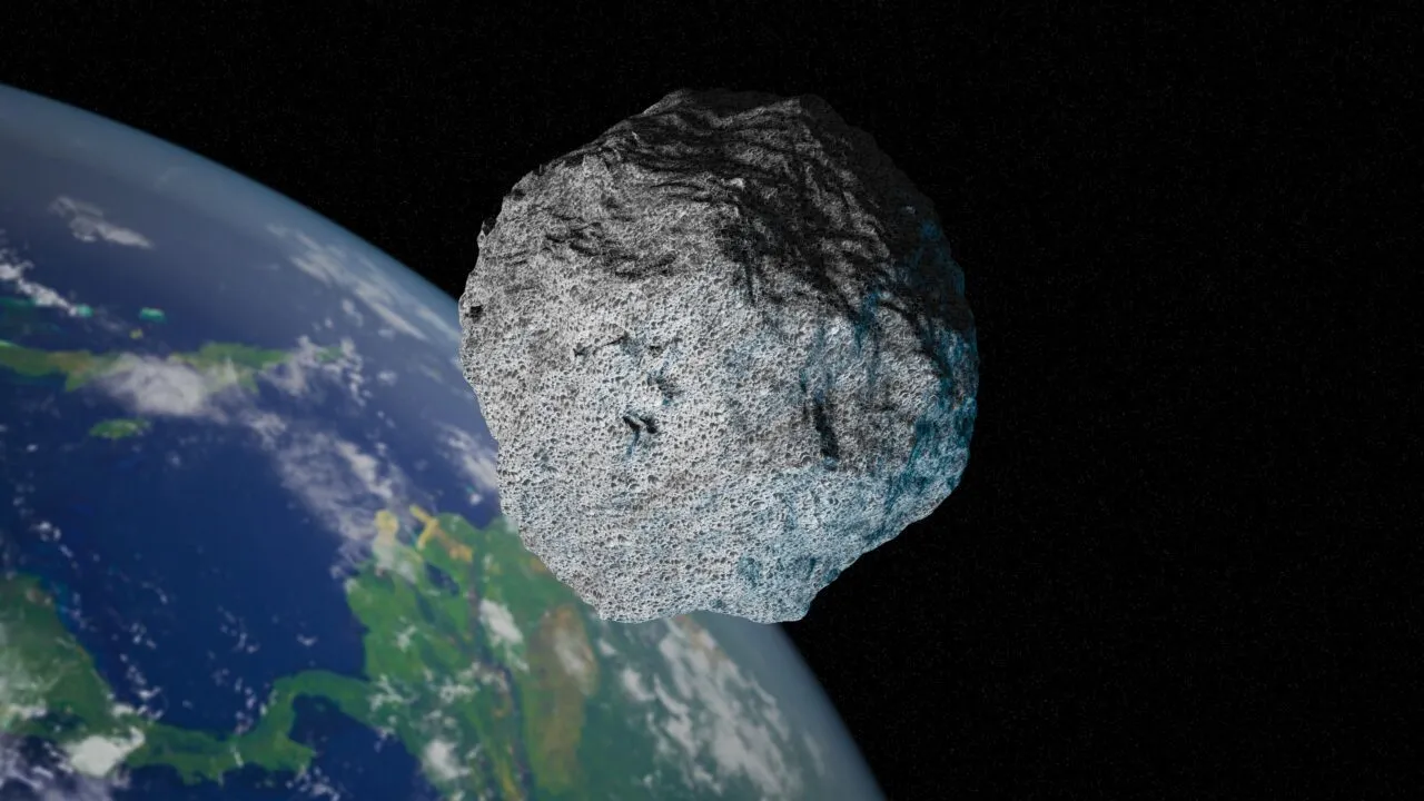 En stor grå asteroide svæver tæt på Jorden i det ydre rum, hvor en del af den blå og grønne planet kan ses på en sort baggrund.